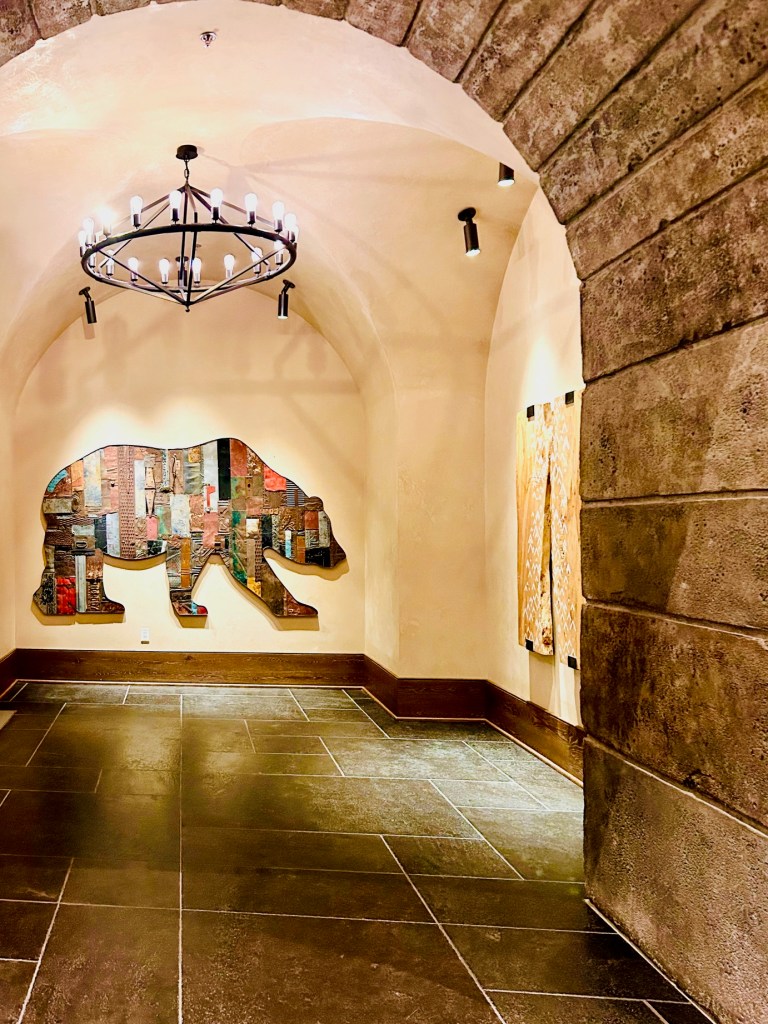 Rustic hallway inside the Gaylord Rockies Resort, featuring warm wood tones, soft lighting, and lodge-style design.