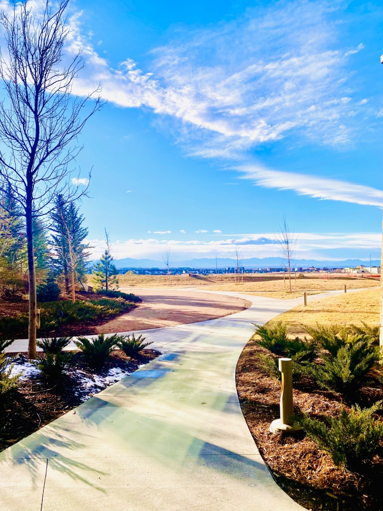Resort courtyard overlooking the Colorado mountains with minimal snow during an unseasonably warm winter.